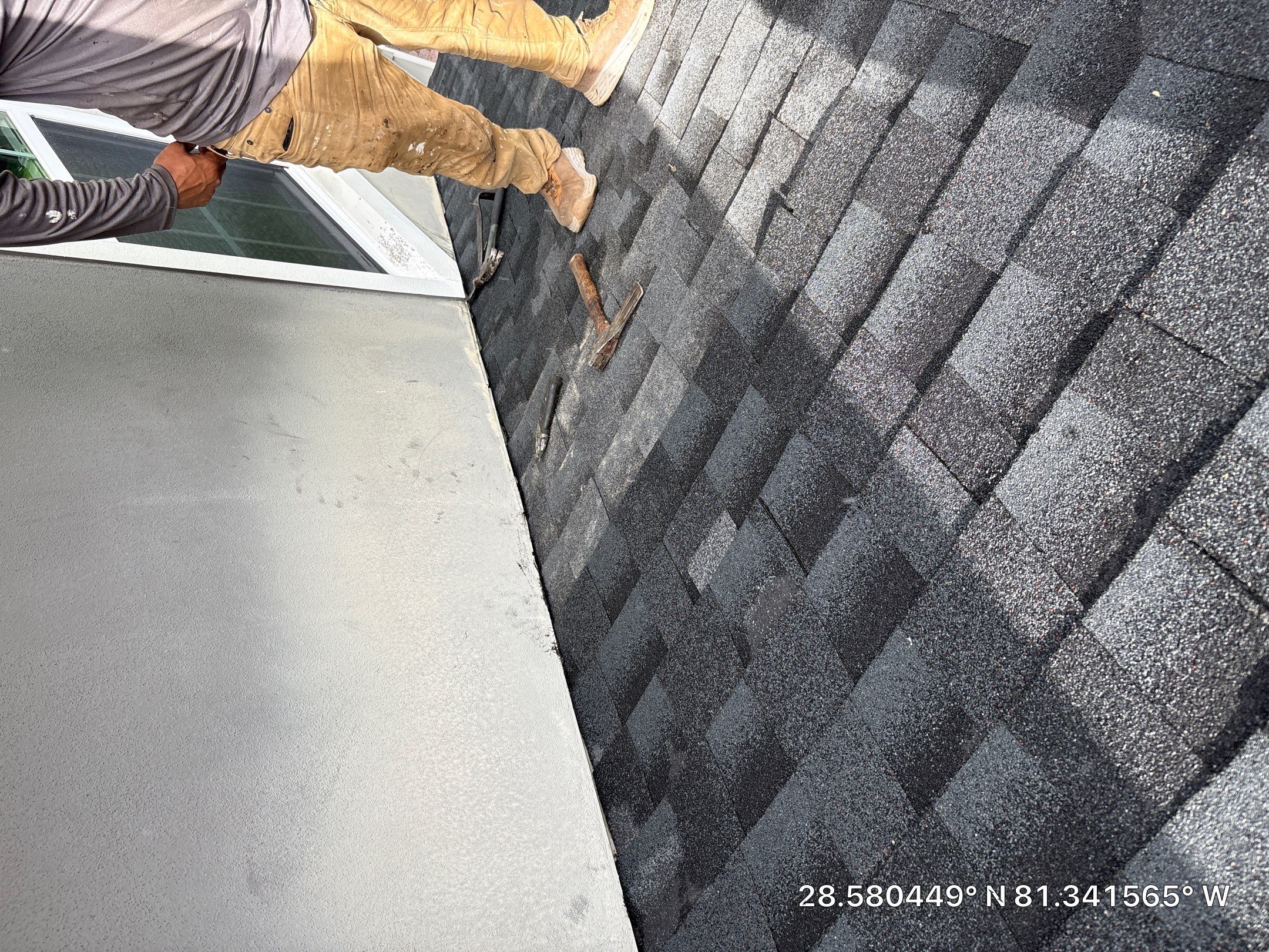 Roofer installing shingles near skylight — Winter Park, FL